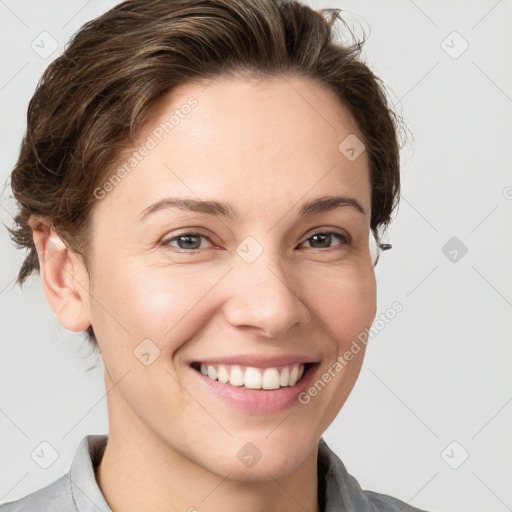 Joyful white young-adult female with short  brown hair and grey eyes