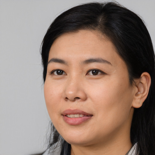 Joyful asian young-adult female with long  black hair and brown eyes