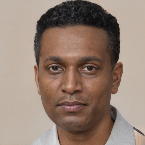 Neutral black young-adult male with short  black hair and brown eyes