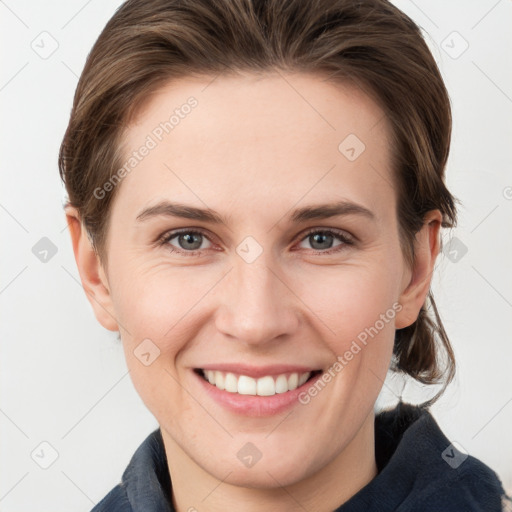 Joyful white young-adult female with medium  brown hair and grey eyes