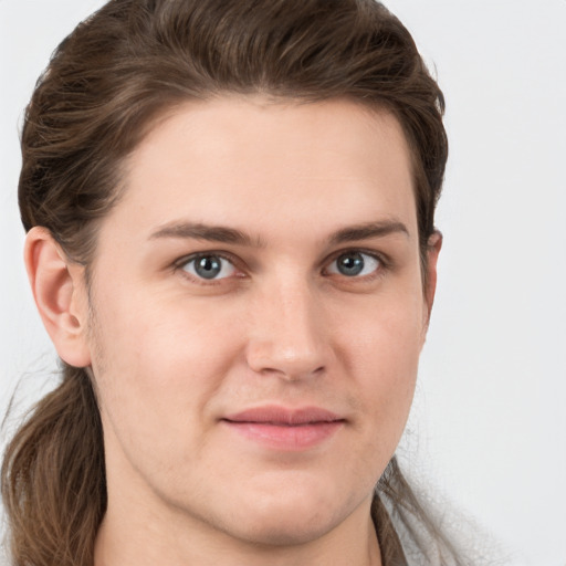 Joyful white young-adult male with long  brown hair and brown eyes