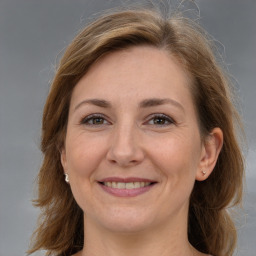 Joyful white adult female with medium  brown hair and grey eyes