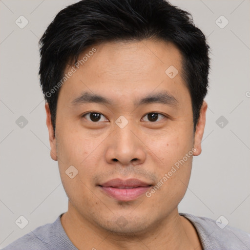 Joyful asian young-adult male with short  black hair and brown eyes