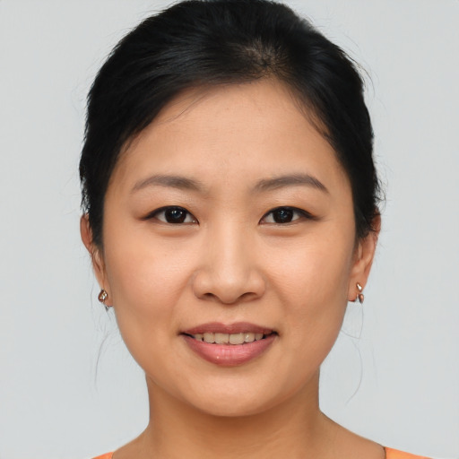 Joyful asian young-adult female with medium  brown hair and brown eyes