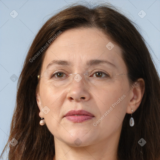 Joyful white adult female with long  brown hair and brown eyes