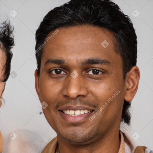 Joyful latino young-adult male with short  brown hair and brown eyes