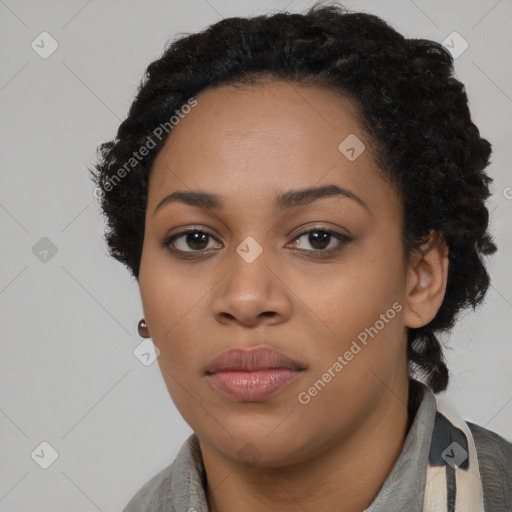 Joyful black young-adult female with long  black hair and brown eyes