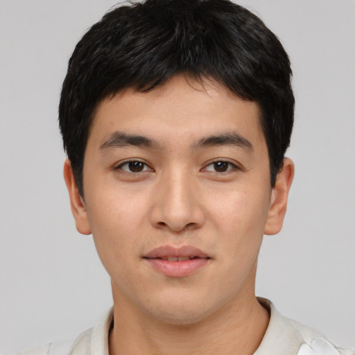 Joyful asian young-adult male with short  black hair and brown eyes