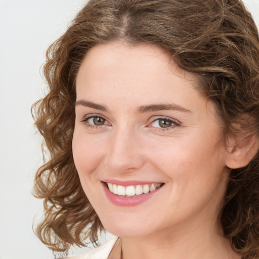 Joyful white young-adult female with medium  brown hair and green eyes