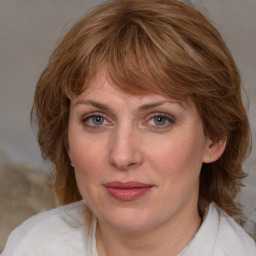 Joyful white adult female with medium  brown hair and blue eyes