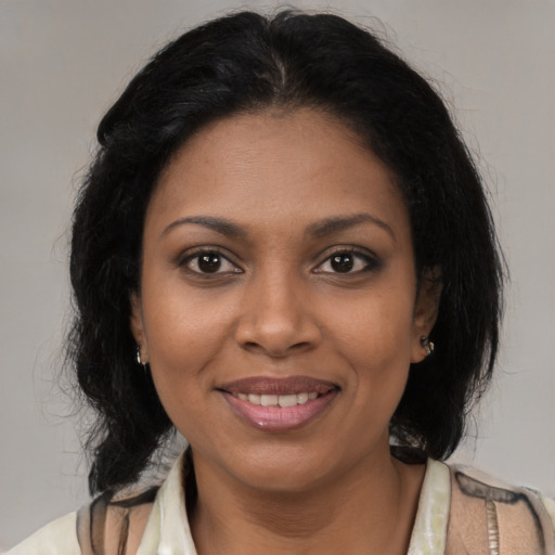 Joyful black young-adult female with medium  brown hair and brown eyes