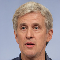 Neutral white middle-aged male with short  gray hair and brown eyes