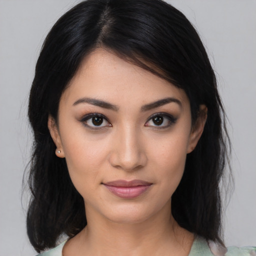 Joyful latino young-adult female with medium  black hair and brown eyes