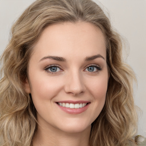 Joyful white young-adult female with long  brown hair and green eyes