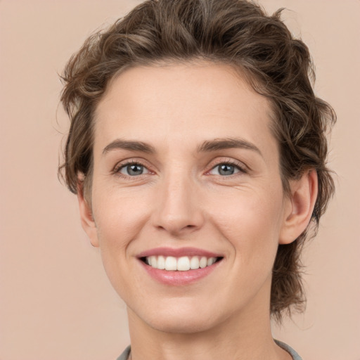 Joyful white young-adult female with medium  brown hair and green eyes