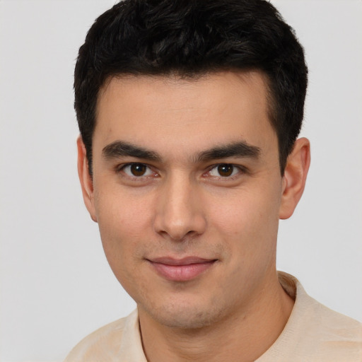 Joyful white young-adult male with short  black hair and brown eyes