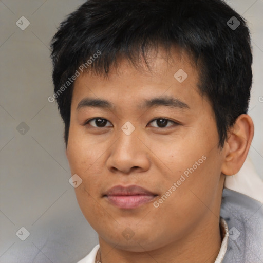 Joyful asian young-adult male with short  brown hair and brown eyes