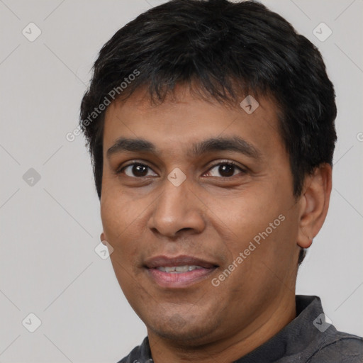 Joyful latino young-adult male with short  black hair and brown eyes