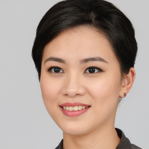 Joyful asian young-adult female with medium  black hair and brown eyes