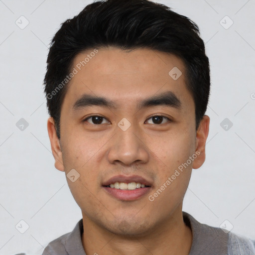 Joyful asian young-adult male with short  black hair and brown eyes