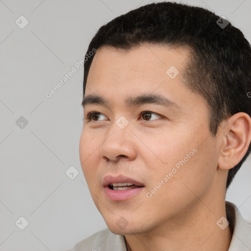 Joyful white young-adult male with short  black hair and brown eyes