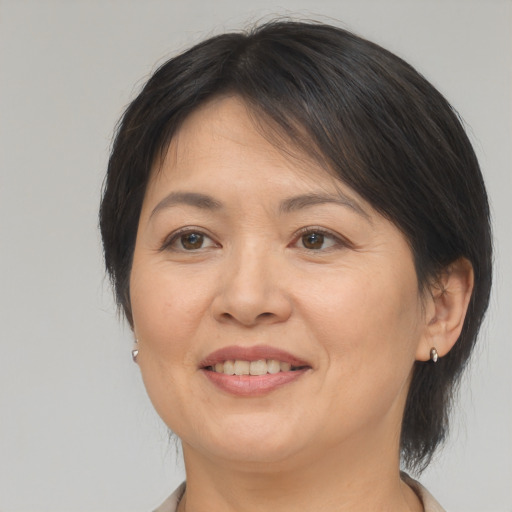 Joyful asian adult female with medium  brown hair and brown eyes