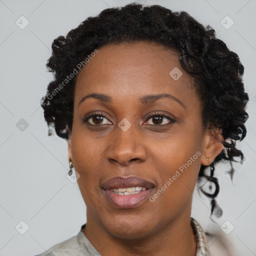 Joyful black adult female with short  brown hair and brown eyes