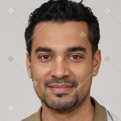 Joyful latino young-adult male with short  black hair and brown eyes