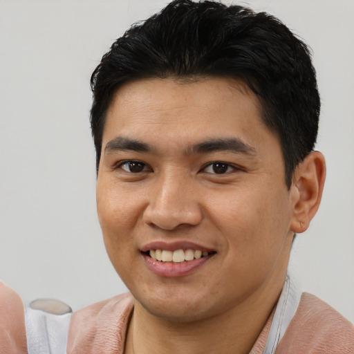 Joyful asian young-adult male with short  black hair and brown eyes