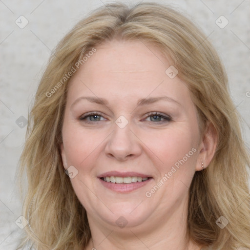 Joyful white adult female with medium  brown hair and blue eyes