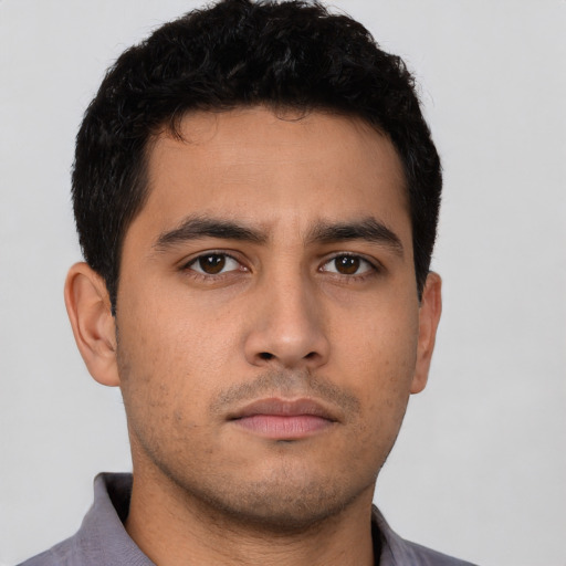 Neutral latino young-adult male with short  brown hair and brown eyes