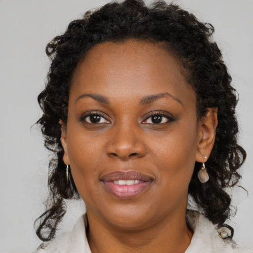 Joyful black young-adult female with medium  brown hair and brown eyes