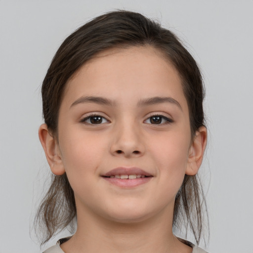 Joyful white child female with medium  brown hair and brown eyes