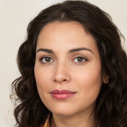 Joyful white young-adult female with long  brown hair and brown eyes