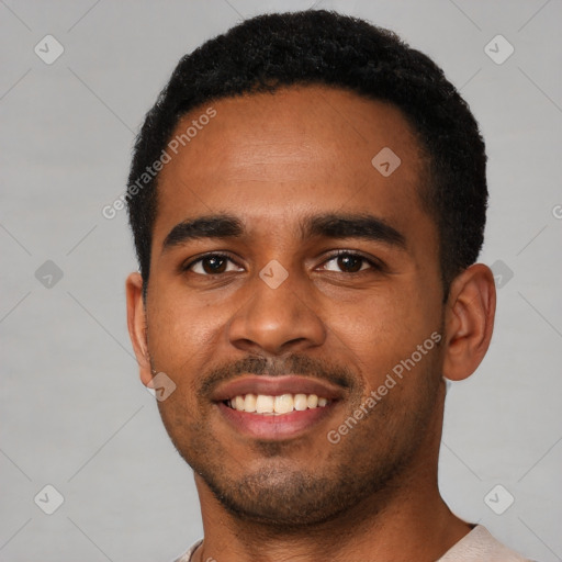 Joyful black young-adult male with short  black hair and brown eyes