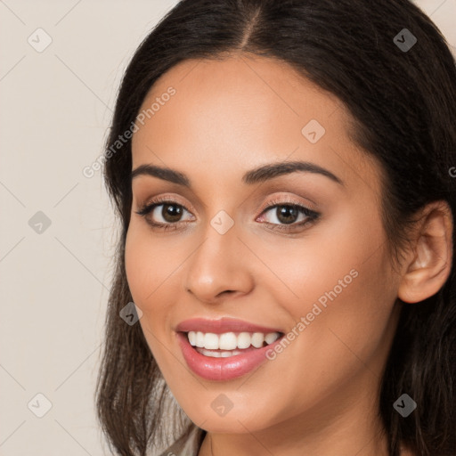 Joyful white young-adult female with long  brown hair and brown eyes