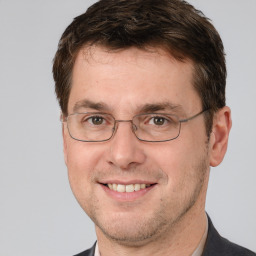 Joyful white adult male with short  brown hair and brown eyes