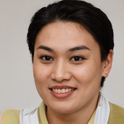 Joyful asian young-adult female with short  brown hair and brown eyes