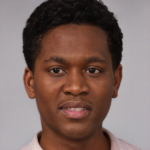Joyful black young-adult male with short  brown hair and brown eyes