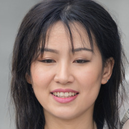 Joyful asian young-adult female with long  brown hair and brown eyes