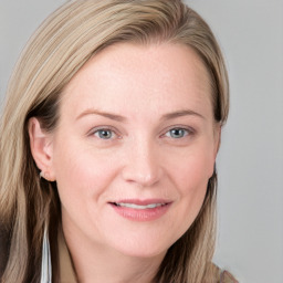 Joyful white young-adult female with long  brown hair and blue eyes