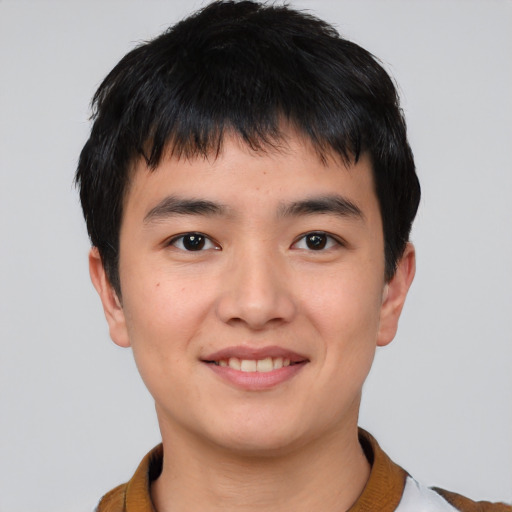 Joyful asian young-adult male with short  black hair and brown eyes