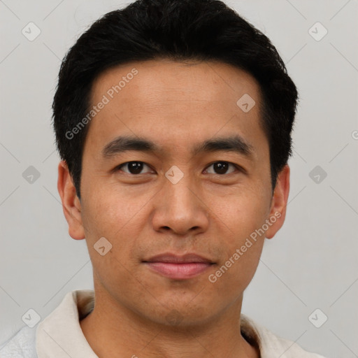 Joyful asian young-adult male with short  black hair and brown eyes