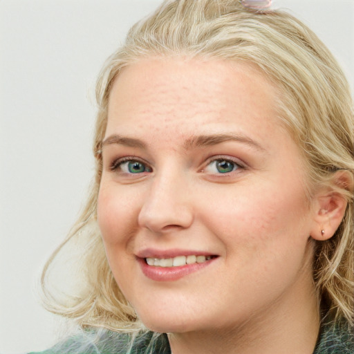 Joyful white young-adult female with long  brown hair and blue eyes