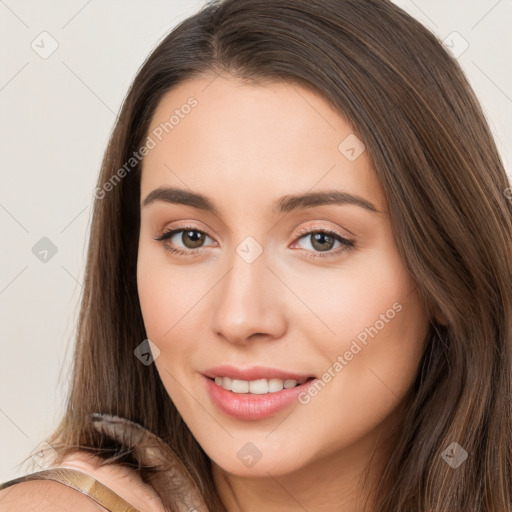 Joyful white young-adult female with long  brown hair and brown eyes