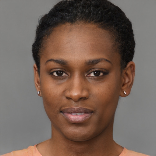 Joyful black young-adult female with short  black hair and brown eyes