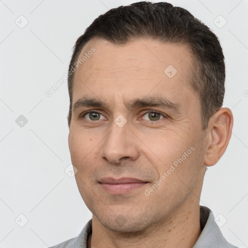 Joyful white adult male with short  brown hair and brown eyes