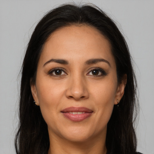 Joyful latino young-adult female with long  brown hair and brown eyes