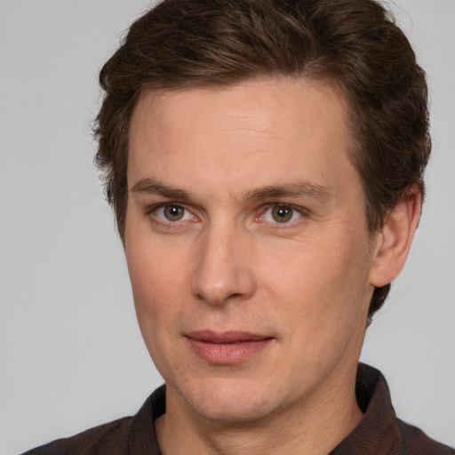 Joyful white adult male with short  brown hair and grey eyes