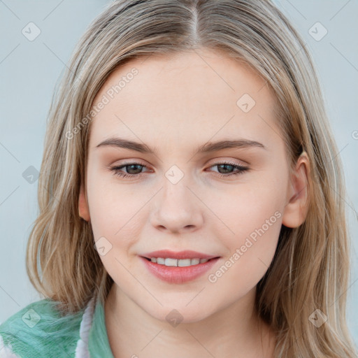 Joyful white young-adult female with long  brown hair and blue eyes